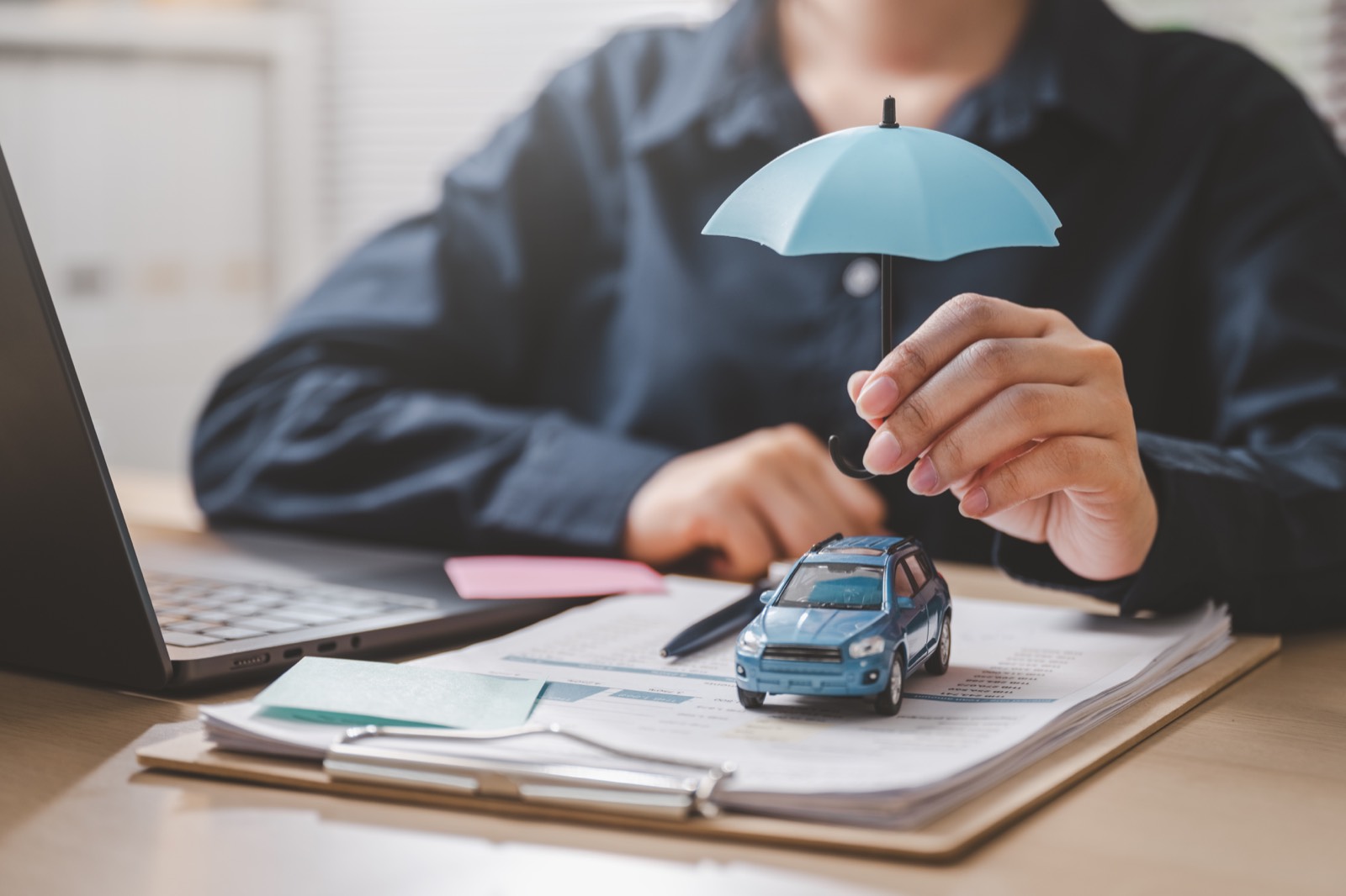 Family and car protected by a yellow umbrella — get an insurance callback